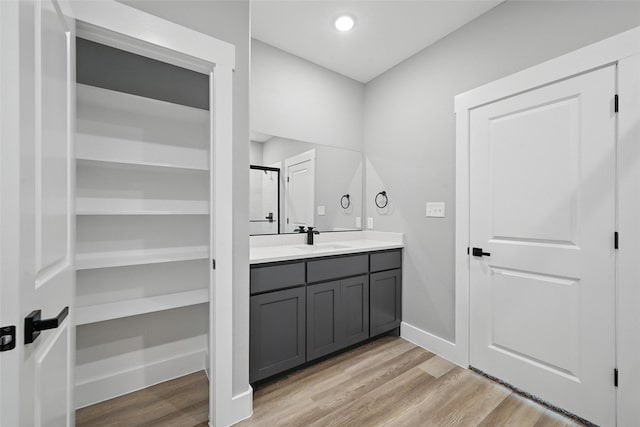 720 W Parnell, Denison, TX 75020 - full bath with wood finished floors, vanity, baseboards, and recessed lighting