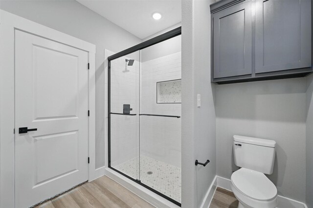 720 W Parnell, Denison, TX 75020 - full bath with a shower stall, wood finished floors, baseboards, and toilet