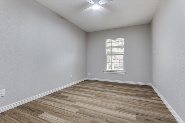 spare room with ceiling fan and light wood-type flooring