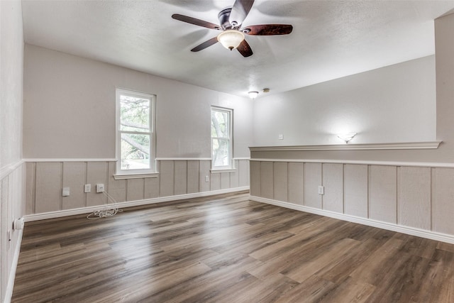 empty room featuring dark hardwood / wood-style flooring and ceiling fan