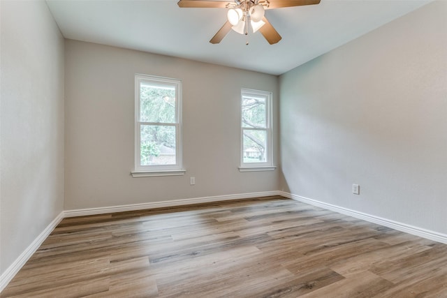 empty room with light hardwood / wood-style flooring, a wealth of natural light, and ceiling fan