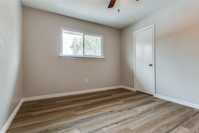 spare room featuring ceiling fan and hardwood / wood-style flooring