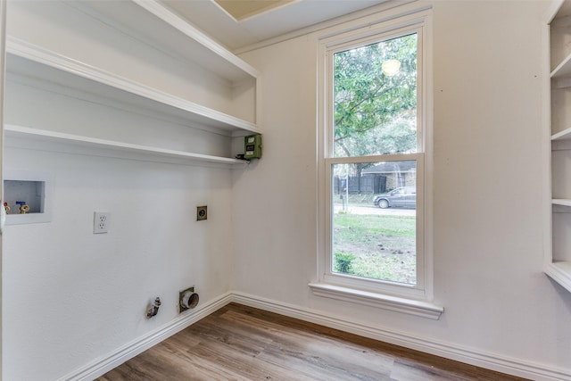 washroom with gas dryer hookup, hardwood / wood-style floors, washer hookup, and hookup for an electric dryer