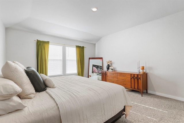 bedroom featuring carpet and vaulted ceiling