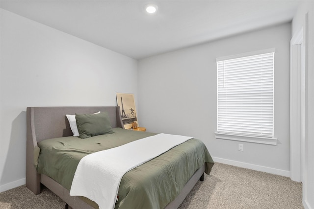 bedroom featuring baseboards and light colored carpet