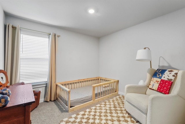 bedroom with baseboards and light colored carpet