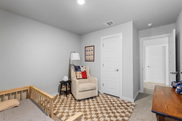 bedroom with carpet and a crib