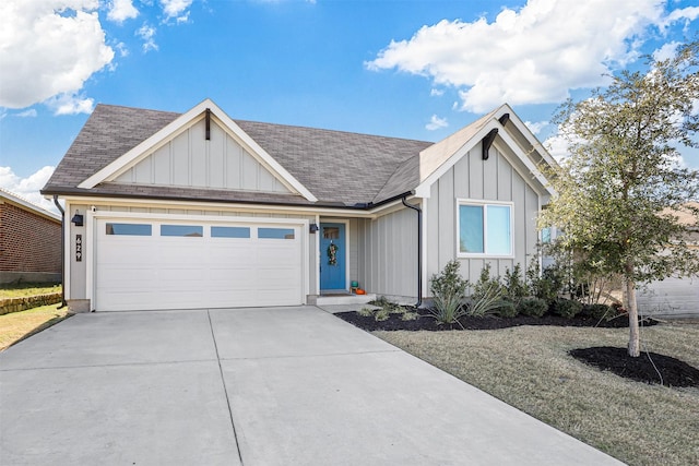 view of front of property with concrete driveway, a shingled roof, board and batten siding, and an attached garage