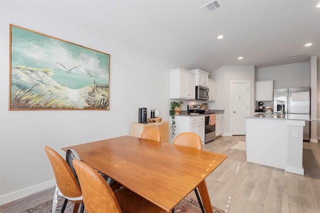 dining area featuring recessed lighting, baseboards, visible vents, and light wood finished floors