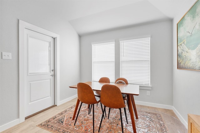 dining space with light wood finished floors and baseboards