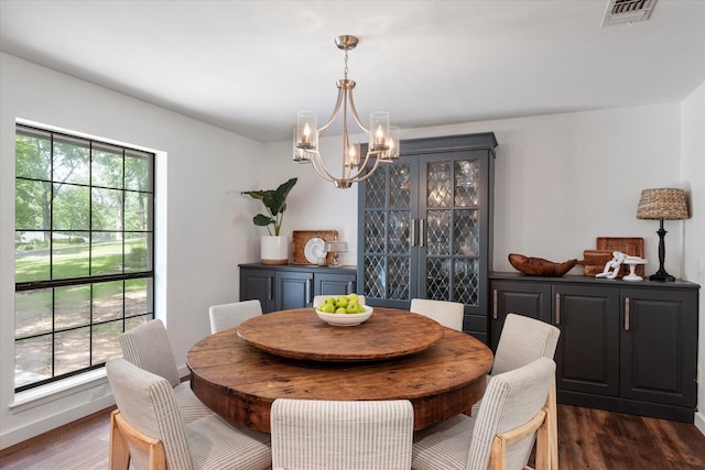 dining space featuring an inviting chandelier and dark hardwood / wood-style floors