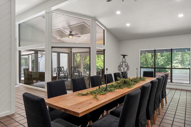 tiled dining room with ceiling fan and lofted ceiling