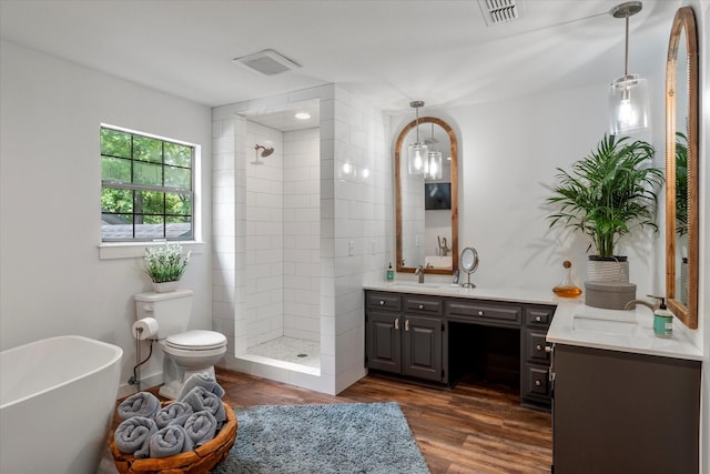 full bathroom with hardwood / wood-style flooring, vanity, separate shower and tub, and toilet