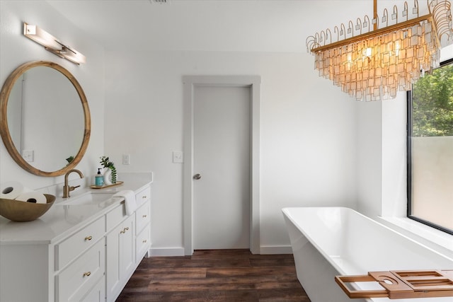 bathroom with vanity, hardwood / wood-style flooring, and a tub