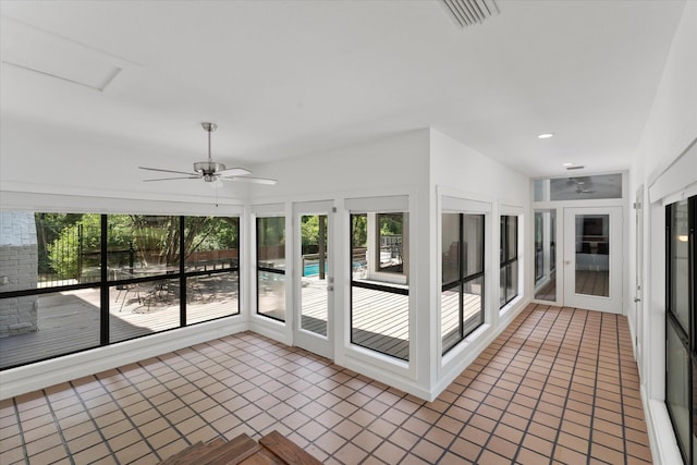 unfurnished sunroom featuring a wealth of natural light and ceiling fan