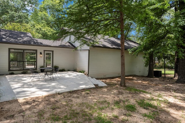 rear view of house with a patio area and central air condition unit