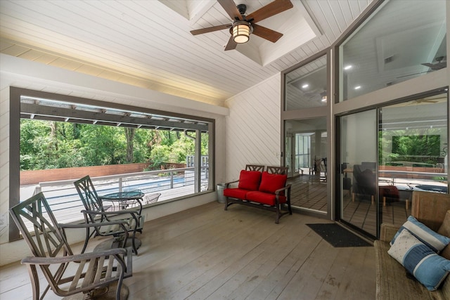 sunroom with ceiling fan and wood ceiling