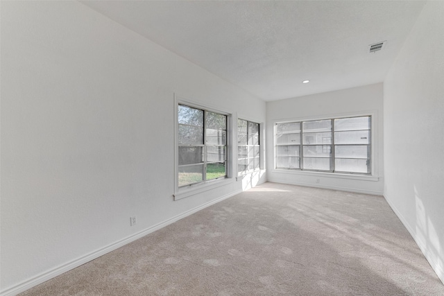 empty room featuring light colored carpet