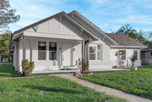 view of front of home featuring covered porch and a front yard