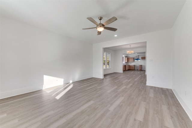 unfurnished living room with light hardwood / wood-style floors and ceiling fan