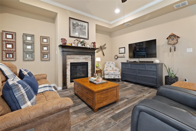 living room featuring crown molding, a fireplace, and dark hardwood / wood-style flooring