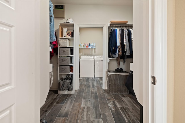 spacious closet featuring dark hardwood / wood-style floors and independent washer and dryer