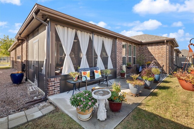 exterior space with a patio area and a lawn