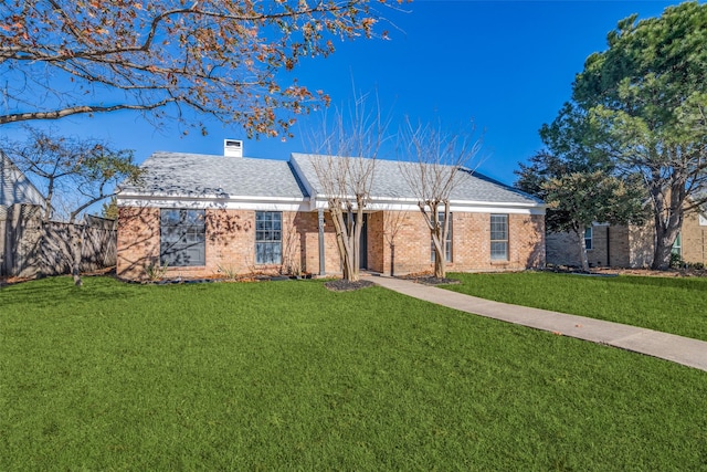 ranch-style home featuring a front yard