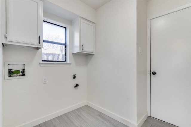 laundry area with hookup for an electric dryer, washer hookup, and cabinets