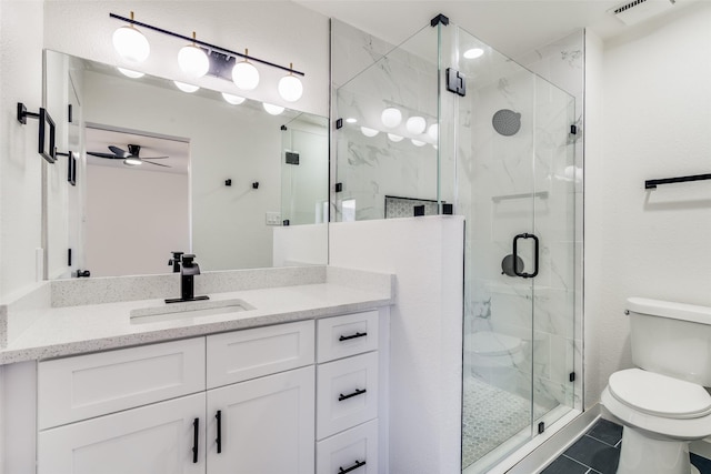 bathroom with ceiling fan, walk in shower, tile patterned floors, toilet, and vanity