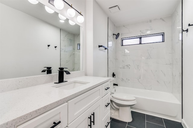 full bathroom with tile patterned floors, toilet, vanity, and tiled shower / bath