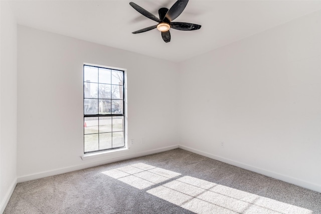 spare room with ceiling fan and light colored carpet