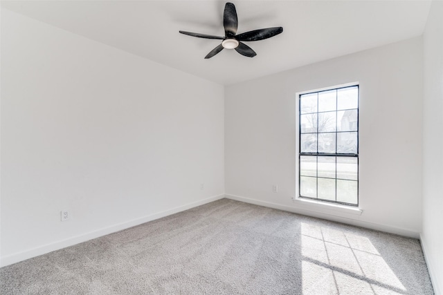 empty room featuring ceiling fan and light carpet