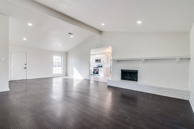 unfurnished living room featuring a fireplace, dark hardwood / wood-style flooring, and lofted ceiling with beams