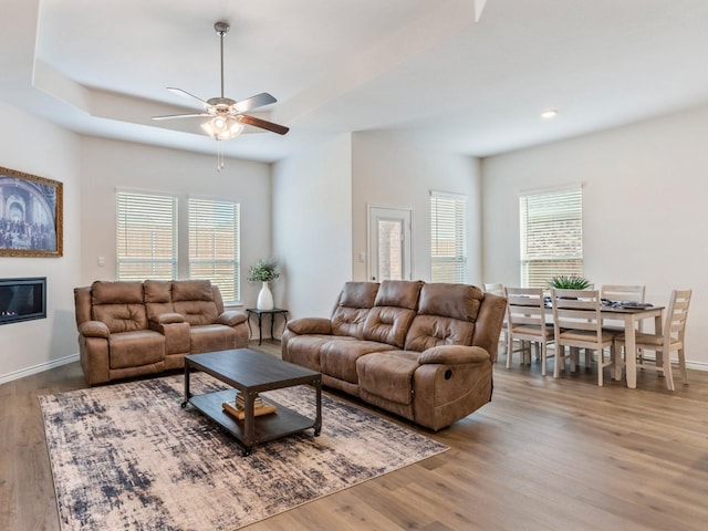 living room featuring wood-type flooring, a wealth of natural light, and ceiling fan