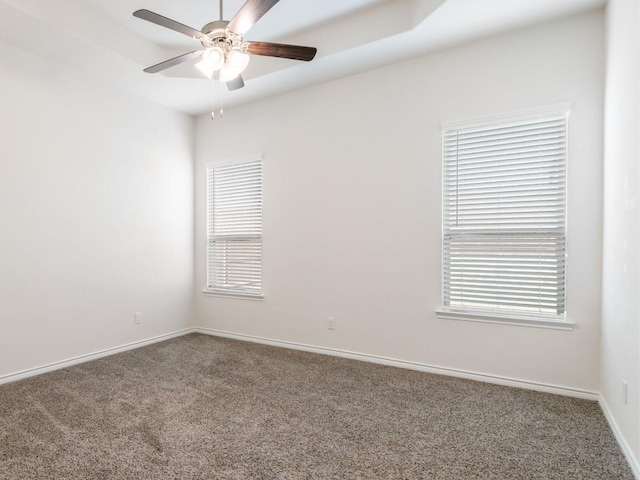 carpeted empty room with plenty of natural light and ceiling fan