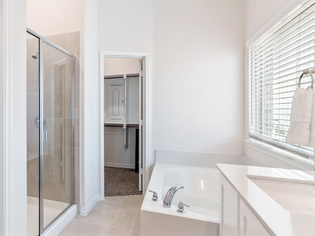 bathroom featuring tile patterned floors, vanity, and separate shower and tub