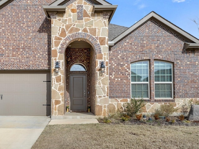 doorway to property with a garage