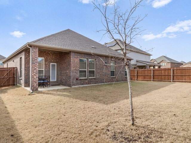 rear view of property with a patio area and a yard