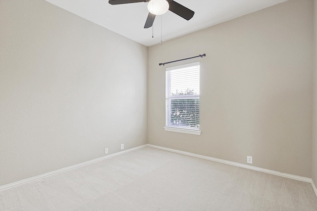 empty room featuring light carpet and ceiling fan