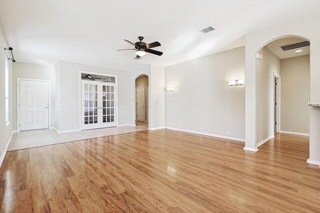 unfurnished living room with ceiling fan and light hardwood / wood-style floors