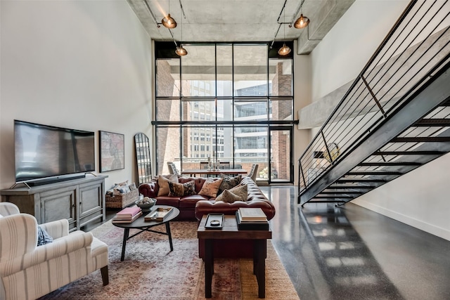 living room featuring floor to ceiling windows and a high ceiling