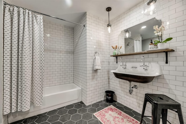 bathroom with shower / bathtub combination with curtain, tile patterned floors, tile walls, and sink