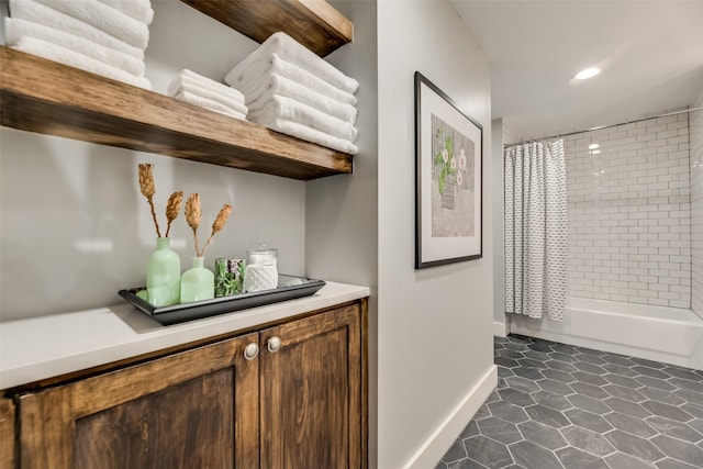 bathroom with vanity, shower / bath combination with curtain, and tile patterned floors