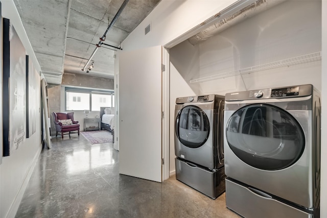 laundry area with washing machine and clothes dryer