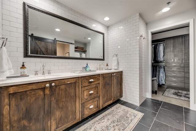 bathroom featuring backsplash, tile patterned flooring, vanity, and tile walls