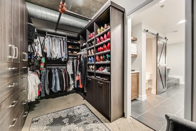 walk in closet with a barn door