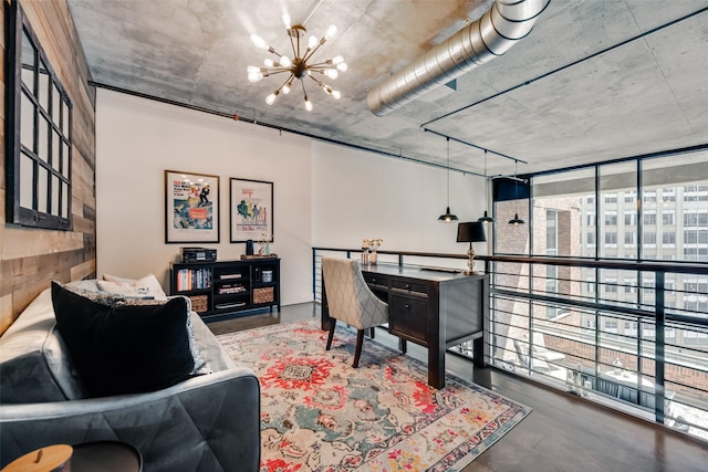 interior space featuring concrete floors, an inviting chandelier, and expansive windows