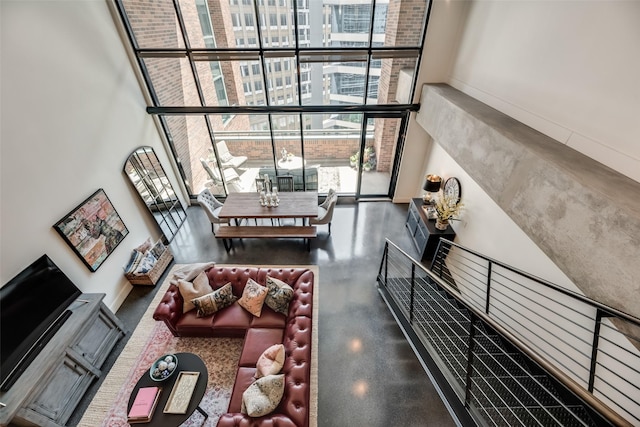 interior space featuring a wall of windows and a towering ceiling