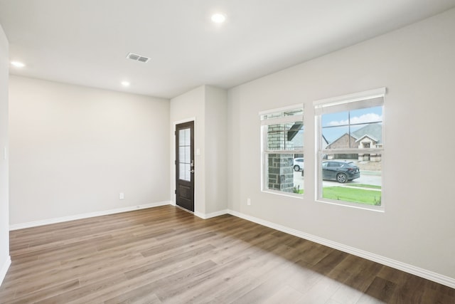 unfurnished room with light wood-type flooring